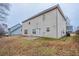 Back view of two-story home with a grassy yard and fencing at 982 Ashton Park Dr, Lawrenceville, GA 30045