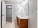 A clean and bright bathroom with wood vanity and tiled flooring at 982 Ashton Park Dr, Lawrenceville, GA 30045