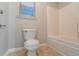 Bathroom featuring a standard toilet and bathtub with shower at 982 Ashton Park Dr, Lawrenceville, GA 30045