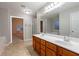 Bright bathroom features a soaking tub, double vanity with cherry cabinets and a separate shower at 982 Ashton Park Dr, Lawrenceville, GA 30045