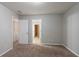 Neutral bedroom featuring carpeted floors and two doorways at 982 Ashton Park Dr, Lawrenceville, GA 30045