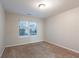 Bright bedroom with a window and neutral carpet at 982 Ashton Park Dr, Lawrenceville, GA 30045