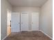 This cozy bedroom features a neutral carpet, light-colored walls, and three doors at 982 Ashton Park Dr, Lawrenceville, GA 30045