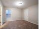 Neutral bedroom featuring a window and carpeted floors at 982 Ashton Park Dr, Lawrenceville, GA 30045