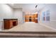 Open dining area with desk and tile flooring, flowing into kitchen with wood cabinets at 982 Ashton Park Dr, Lawrenceville, GA 30045