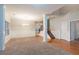 A dining room features an elegant chandelier, paneled walls, and hardwood floors by a stairway at 982 Ashton Park Dr, Lawrenceville, GA 30045