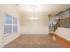 A dining room features a chandelier, paneled walls, and hardwood floors near carpeted area at 982 Ashton Park Dr, Lawrenceville, GA 30045