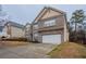 Well-maintained two-story house with brick exterior, two-car garage, and landscaped front yard at 982 Ashton Park Dr, Lawrenceville, GA 30045