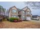 Charming two-story brick home with manicured front yard and attached two-car garage at 982 Ashton Park Dr, Lawrenceville, GA 30045