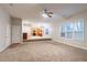 Bright and airy living room with carpet, open floor plan, and a view to the kitchen at 982 Ashton Park Dr, Lawrenceville, GA 30045