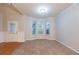 The living room is complete with large windows, neutral paint, and neutral carpet at 982 Ashton Park Dr, Lawrenceville, GA 30045