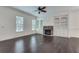 Spacious living room with hardwood floors, fireplace, and custom built-in shelving at 110 Rose Garden Ln, Alpharetta, GA 30009