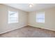 This bedroom features neutral carpeting, neutral walls and a pair of windows at 2080 Dellwood Pl, Decatur, GA 30032