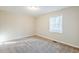 This bedroom features neutral carpeting, neutral walls and a large window at 2080 Dellwood Pl, Decatur, GA 30032