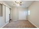 This bedroom features neutral carpeting, a ceiling fan and a sliding closet door at 2080 Dellwood Pl, Decatur, GA 30032