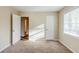 This bedroom features neutral carpeting, a closet and a large window at 2080 Dellwood Pl, Decatur, GA 30032
