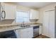 Bright kitchen featuring white cabinets, granite countertops, and stainless steel appliances at 2080 Dellwood Pl, Decatur, GA 30032