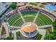 Aerial view featuring stepped seating, a central stage, and landscaping to a popular amphitheater in Sugar Hill at 608 Sweetfern Ln, Sugar Hill, GA 30518