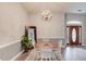 Bright dining room featuring a chandelier, and view of the front door at 608 Sweetfern Ln, Sugar Hill, GA 30518