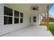 Spacious covered patio with a ceiling fan and large windows overlooking the landscaped backyard at 2021 Shallowford Rd, Marietta, GA 30066