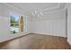 Dining room features hardwood floors, wainscoting, and a modern chandelier at 2021 Shallowford Rd, Marietta, GA 30066