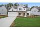Charming two-story home featuring a two-car garage and a well-manicured lawn at 2021 Shallowford Rd, Marietta, GA 30066