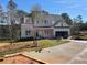 Two-story home boasts a manicured front yard, inviting entryway, and an attached two-car garage at 2021 Shallowford Rd, Marietta, GA 30066
