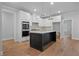 Modern kitchen featuring an island, stainless steel appliances, and white cabinetry at 2021 Shallowford Rd, Marietta, GA 30066