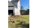 A side view of a home showing fresh sod and an in-ground sprinkler system at 2021 Shallowford Rd, Marietta, GA 30066