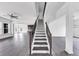 Spacious entryway featuring a staircase with dark railings and hardwood floors at 2890 Longbush Lane, Duluth, GA 30097