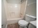 This bathroom features a shower-tub combo and a modern toilet at 5087 Donnell Way, Decatur, GA 30035