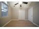 This room features neutral paint, a ceiling fan, and a large window providing natural light at 5087 Donnell Way, Decatur, GA 30035