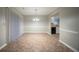 Open dining area adjacent to the kitchen with neutral walls, tile flooring, and modern lighting fixtures at 5087 Donnell Way, Decatur, GA 30035