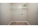 This laundry room has utility connections and a rack for extra storage at 5087 Donnell Way, Decatur, GA 30035