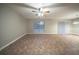 Spacious living room featuring modern tile floors, a ceiling fan, and a large window that offers plenty of natural light at 5087 Donnell Way, Decatur, GA 30035