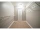 Walk-in closet featuring tile flooring, metal shelves and white door at 5087 Donnell Way, Decatur, GA 30035
