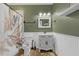 Cozy bathroom features a vanity, toilet, shower with colorful shower curtain and a tile floor at 6740 Mountain Lake Ln, Cumming, GA 30028