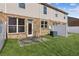 View of the home's backyard with green grass, partial fence and a small patio at 2293 Chancery Mill Ln, Buford, GA 30519