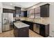 Kitchen featuring stainless steel appliances, dark cabinetry, and granite countertops at 2293 Chancery Mill Ln, Buford, GA 30519