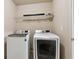 Laundry room features a washer, a dryer, and storage shelf at 2293 Chancery Mill Ln, Buford, GA 30519