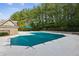 View of the community pool covered in winter, surrounded by lush trees and a patio with furniture at 2293 Chancery Mill Ln, Buford, GA 30519