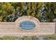 Community welcome sign 'The Townes of Avondale' set in a brick wall and manicured landscaping at 2293 Chancery Mill Ln, Buford, GA 30519