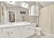 Bright bathroom featuring double sink vanity, white cabinetry, and a large mirror at 236 Balaban Cir, Woodstock, GA 30188