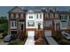 Charming townhome with a one-car garage, brick accents, and landscaped entrance at 236 Balaban Cir, Woodstock, GA 30188