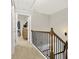 Second floor hallway with carpet and wood railing at 236 Balaban Cir, Woodstock, GA 30188