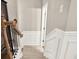 Hallway near the staircase featuring decorative wainscoting and wood railing at 236 Balaban Cir, Woodstock, GA 30188