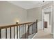 Upstairs hallway with carpet and railings at 236 Balaban Cir, Woodstock, GA 30188