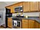 Kitchen featuring stainless steel oven, microwave and refrigerator with wooden cabinets at 236 Balaban Cir, Woodstock, GA 30188