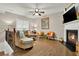 Bright living room featuring a fireplace, hardwood floors, and a ceiling fan at 236 Balaban Cir, Woodstock, GA 30188