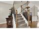 Carpeted staircase with wooden handrail and black iron balusters at 236 Balaban Cir, Woodstock, GA 30188